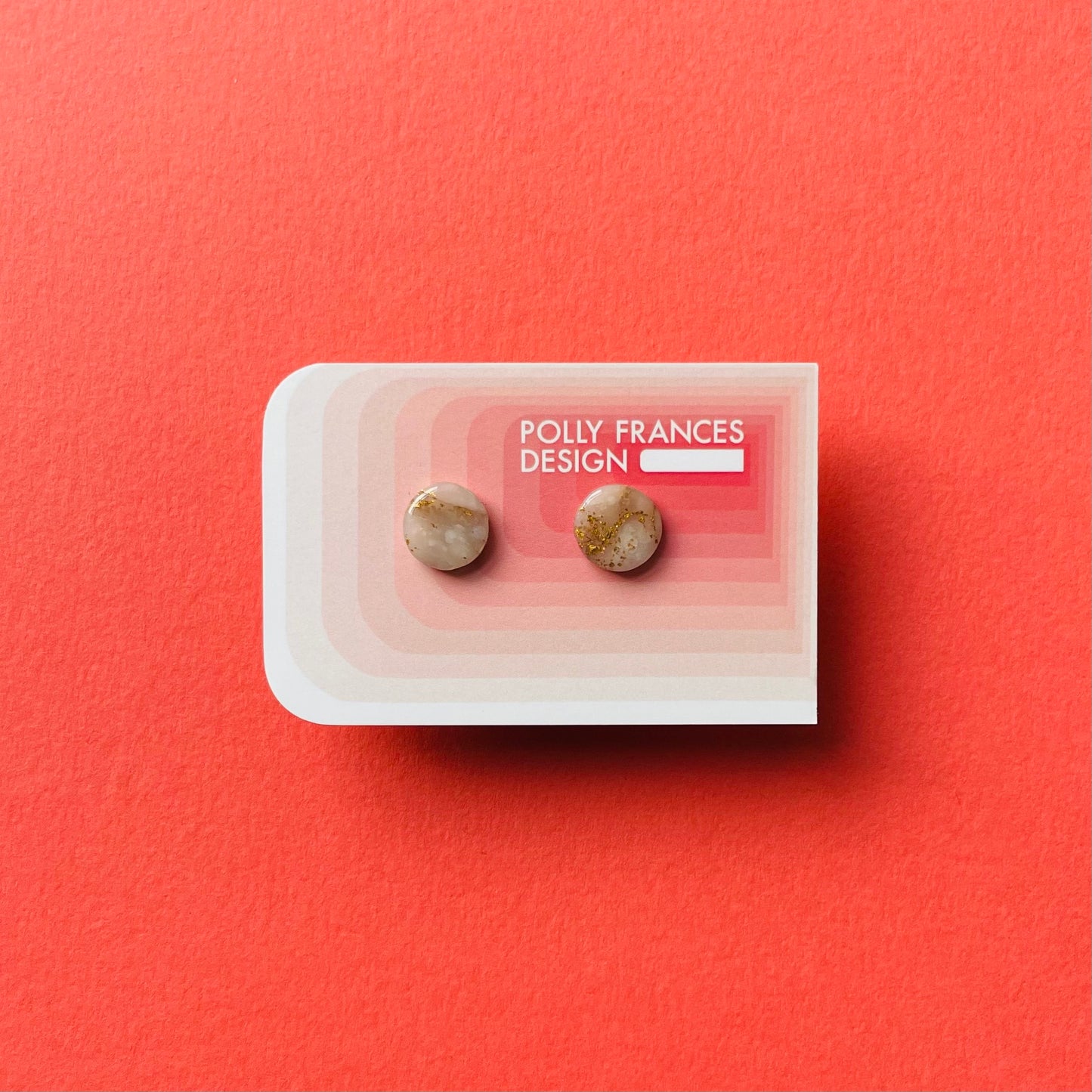 Gold Studs Sitting On Branded Polly Frances Design Card