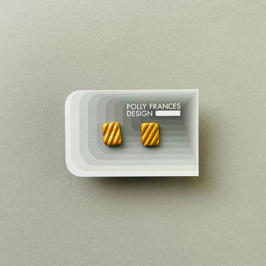 Gold Studs Sitting On Branded Polly Frances Design Card