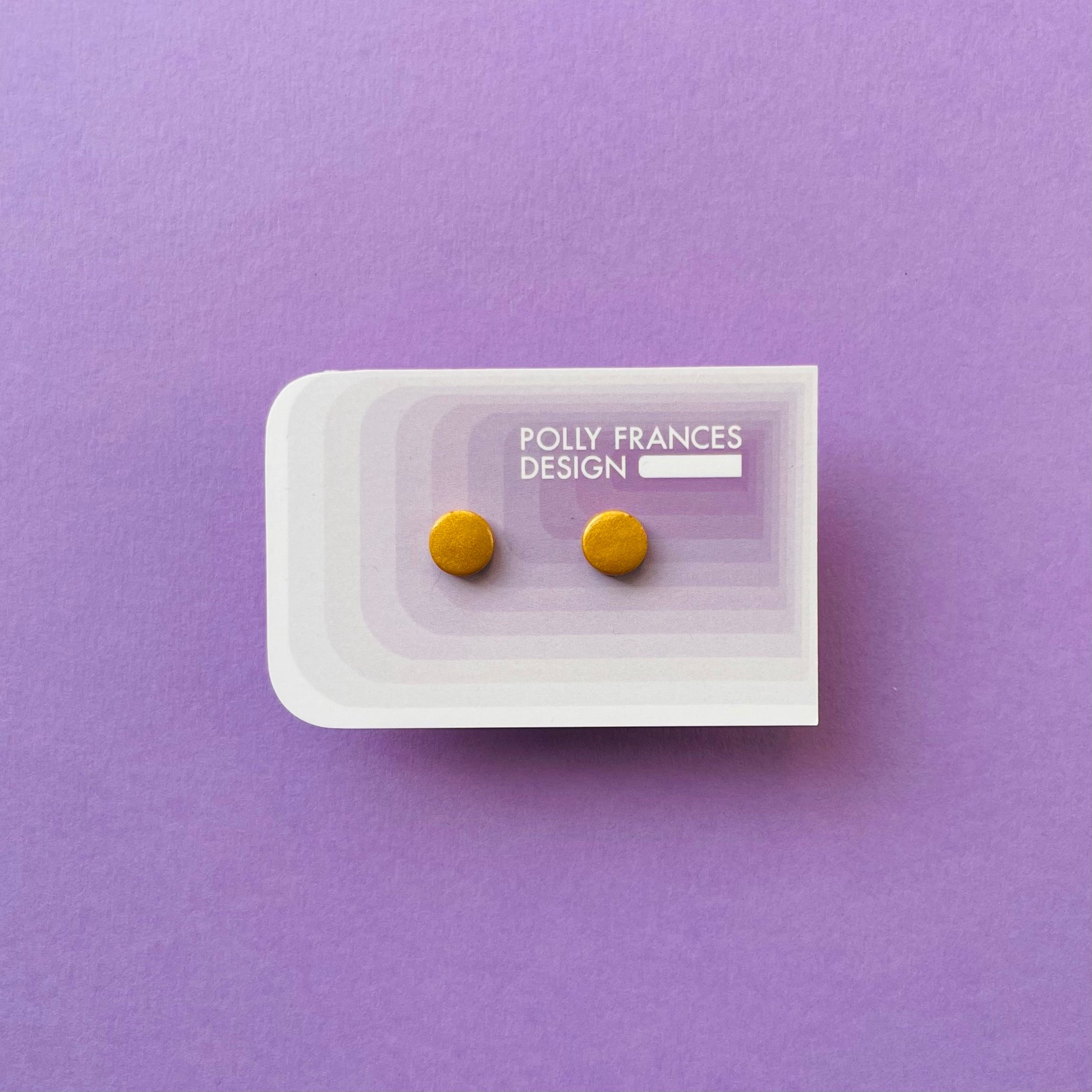 Gold Studs Sitting On Branded Polly Frances Design Card