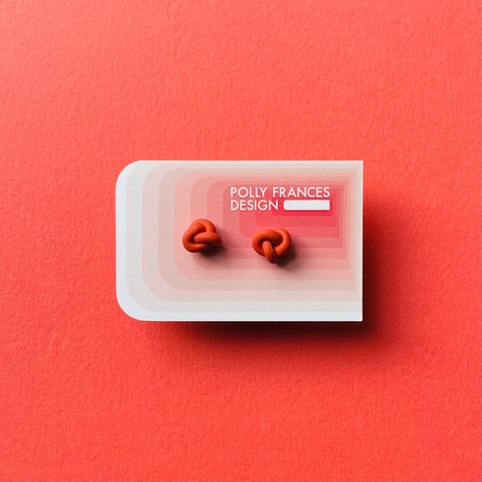 Rust Studs Sitting On Branded Polly Frances Design Card